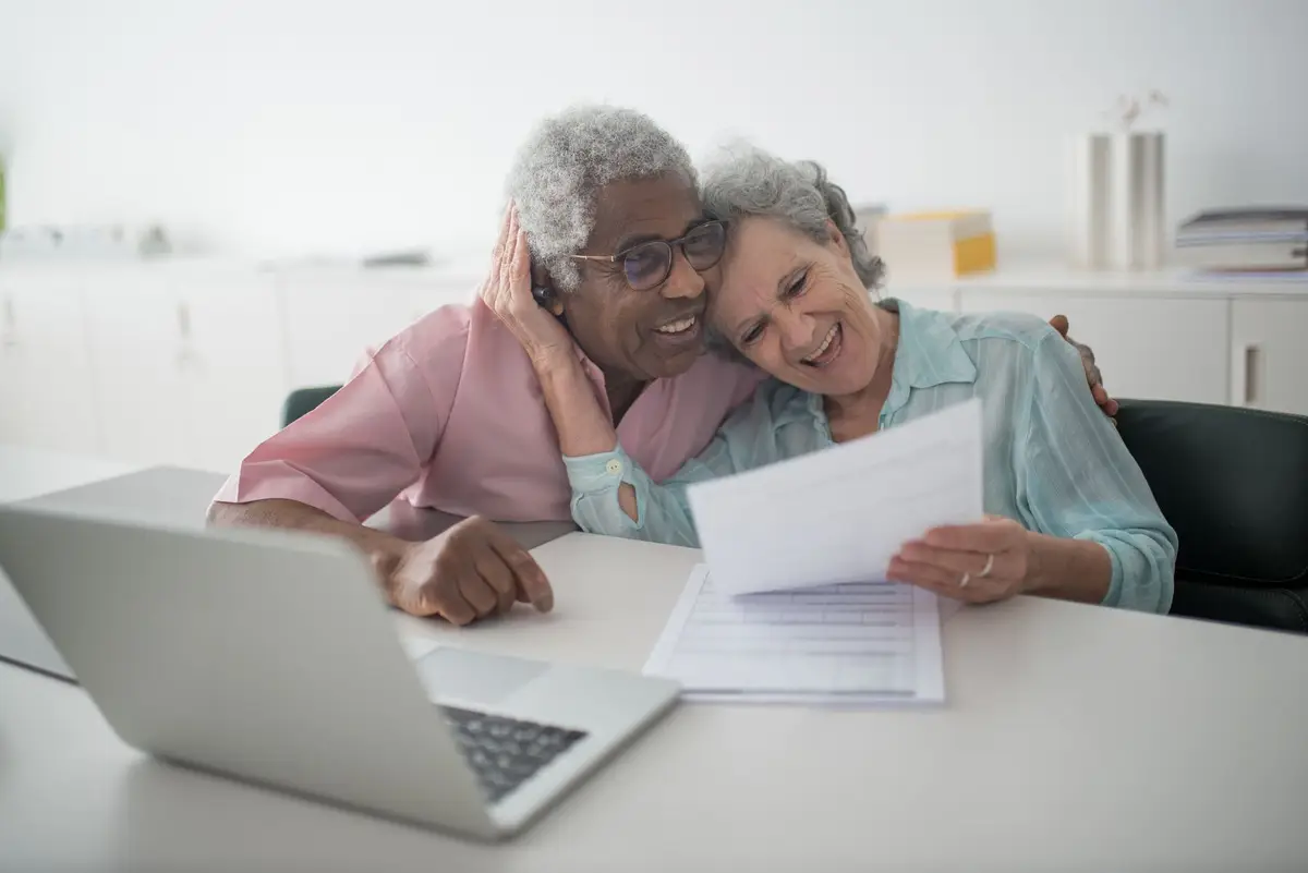 Older couple reviewing paperwork at the kitchen table (Walk-in tub cost in Utah: what changes the price)